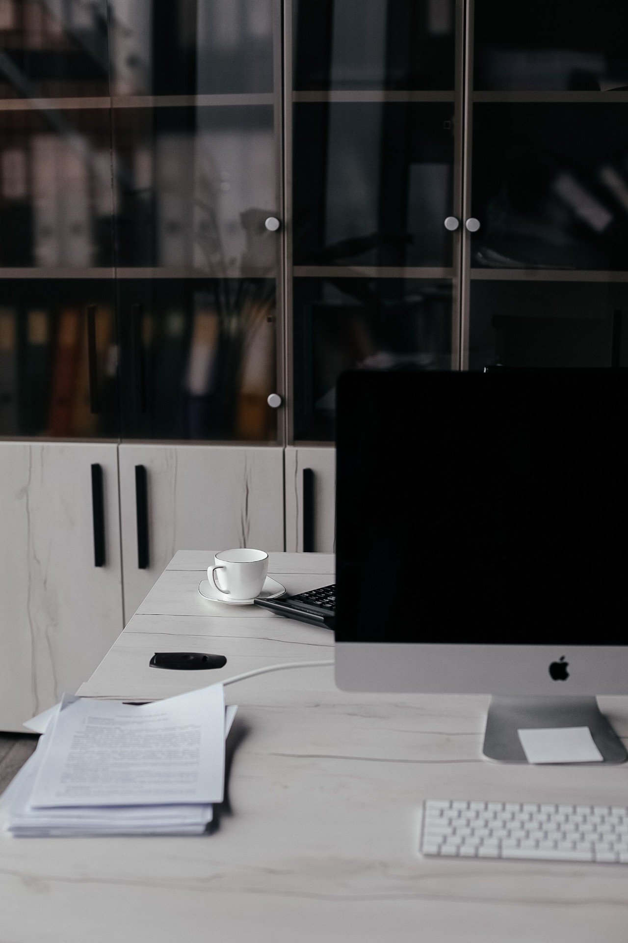 Office workstation with documents and desktop monitor ready for fast trade execution